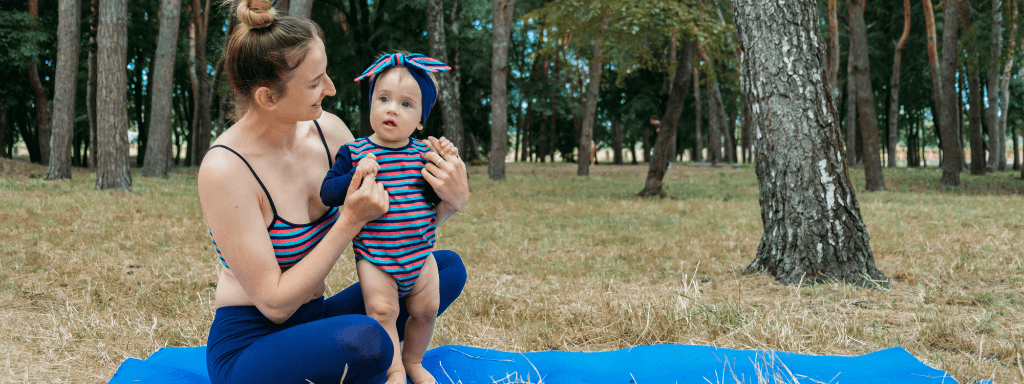 Outdoor baby class - image shows a mother and baby at a baby yoga class