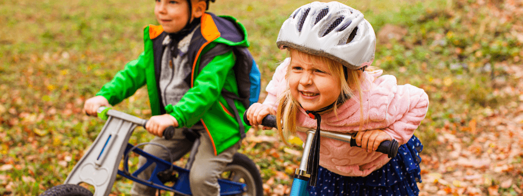 Children in the park riding on their scooters and bikes