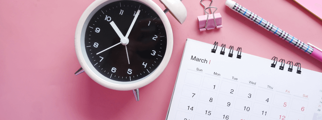 Clock and calendar on a pink background
